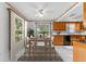 Dining room with views to the lake, wood cabinets, and white tile floors at 5377 Springwood Blvd, Pinellas Park, FL 33782