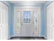 Elegant entryway features a decorative glass front door, sidelights and white trim on the closet doors at 5377 Springwood Blvd, Pinellas Park, FL 33782