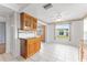 Charming eat-in kitchen with honey-toned cabinets, tiled floors, and a sunny view of the backyard at 5377 Springwood Blvd, Pinellas Park, FL 33782