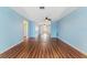 Spacious room with wood floors and a ceiling fan in the center; leads to other parts of the house at 5377 Springwood Blvd, Pinellas Park, FL 33782