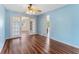 Bright living room with wood floors and glass doors which lead to another area of the home at 5377 Springwood Blvd, Pinellas Park, FL 33782