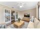 Open concept living room with wood floors, neutral colors, and view to the dining room at 5377 Springwood Blvd, Pinellas Park, FL 33782