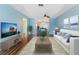 Bright living room with hardwood floors, a white sofa, and calming blue accent walls at 5377 Springwood Blvd, Pinellas Park, FL 33782