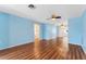 Large living room featuring wood floors and two ceiling fans providing air circulation at 5377 Springwood Blvd, Pinellas Park, FL 33782