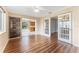 Spacious living room with hardwood floors, decorative glass sliding doors, and an open view to the eat-in kitchen at 5377 Springwood Blvd, Pinellas Park, FL 33782