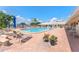 Outdoor pool area with lounge chairs, tables, and lush tropical plants at 5377 Springwood Blvd, Pinellas Park, FL 33782