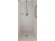 Modern shower featuring sleek fixtures, handrail, and mosaic tile flooring at 5377 Springwood Blvd, Pinellas Park, FL 33782