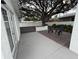 Backyard featuring a concrete patio, wood deck, mature tree, and white fencing at 539 Freeport N Ave, St Petersburg, FL 33702
