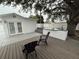 Backyard with a concrete patio, wood deck, an outdoor kitchen and mature tree at 539 Freeport N Ave, St Petersburg, FL 33702