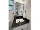 Bathroom sink with granite countertops, matte black hardware and a framed mirror at 539 Freeport N Ave, St Petersburg, FL 33702