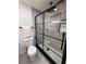 Modern bathroom featuring a glass shower with black trim and sleek fixtures at 539 Freeport N Ave, St Petersburg, FL 33702