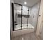 Bathroom featuring a shower with a new glass shower door, and tile surround at 539 Freeport N Ave, St Petersburg, FL 33702