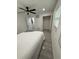 This bright bedroom features tile floors, a ceiling fan, and a closet for storage at 539 Freeport N Ave, St Petersburg, FL 33702