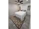 Bedroom features a modern ceiling fan, white bedding, and stylish rug at 539 Freeport N Ave, St Petersburg, FL 33702