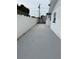 Long concrete driveway to a white house with white fencing at 539 Freeport N Ave, St Petersburg, FL 33702