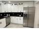 This kitchen features white cabinets, stainless steel appliances, and black granite countertops at 539 Freeport N Ave, St Petersburg, FL 33702