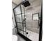 Modern shower with sleek glass door, rainfall shower head, and built-in shelving at 539 Freeport N Ave, St Petersburg, FL 33702