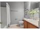 Bright bathroom with vanity, decorative mirrors, toilet, and shower with glass doors at 589 52Nd N Ave, St Petersburg, FL 33703
