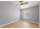 Well-lit bedroom with ceiling fan, window and wood-look flooring at 589 52Nd N Ave, St Petersburg, FL 33703