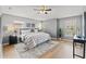 This main bedroom is spacious with wood-look floors, ceiling fan, natural light and gray decor at 589 52Nd N Ave, St Petersburg, FL 33703