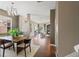 Open-concept dining room with wood floors, large windows, and views of the living room at 589 52Nd N Ave, St Petersburg, FL 33703