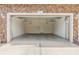 Spacious garage with shelving and an interior door, perfect for storage or parking vehicles at 589 52Nd N Ave, St Petersburg, FL 33703