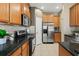 Close-up of a kitchen with stainless steel appliances, wood cabinets, and tile backsplash at 589 52Nd N Ave, St Petersburg, FL 33703