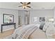 Stylish main bedroom with wood-look floors, ceiling fan, natural light and gray decor at 589 52Nd N Ave, St Petersburg, FL 33703