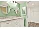 Bright bathroom featuring double sinks with modern faucets and vanity, oval mirrors, and access to walk-in closet at 6361 92Nd N Pl # 1704, Pinellas Park, FL 33782