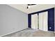 Bedroom featuring gray walls with a blue accent wall and large windows, offering plenty of natural light at 6361 92Nd N Pl # 1704, Pinellas Park, FL 33782