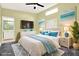 Stylishly decorated main bedroom with ceiling fan, ensuite bathroom, and serene beach artwork at 6361 92Nd N Pl # 1704, Pinellas Park, FL 33782