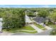 Aerial view of house with a well-manicured lawn, driveway, and view of the community pond at 6621 Appaloosa Dr, Tampa, FL 33625