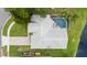 Aerial view of house featuring a private pool, fenced-in yard, brick paved driveway and lush landscaping at 6621 Appaloosa Dr, Tampa, FL 33625