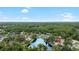 Beautiful aerial view of house backing up to a large pond surrounded by mature trees in a quiet neighborhood at 6621 Appaloosa Dr, Tampa, FL 33625