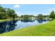 This yard features a beautiful pond view with mature trees and pristine landscaping at 6621 Appaloosa Dr, Tampa, FL 33625
