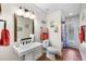 Full bathroom with earth-toned tile flooring, a pedestal sink, and a walk-in shower at 6621 Appaloosa Dr, Tampa, FL 33625