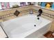 Soaking bathtub with decorative tile and modern fixtures, perfect for relaxation at 6621 Appaloosa Dr, Tampa, FL 33625