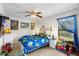 Bedroom featuring carpet, a ceiling fan, and colorful decor at 6621 Appaloosa Dr, Tampa, FL 33625