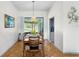 Bright dining room features parquet floors, a decorative chandelier, and sliding glass doors to the pool at 6621 Appaloosa Dr, Tampa, FL 33625