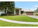 Charming single-story home with a well-maintained lawn, lush landscaping, and a two-car garage at 6621 Appaloosa Dr, Tampa, FL 33625