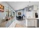 Well-lit kitchen with granite countertops, white cabinets, and access to the dining area and backyard at 6621 Appaloosa Dr, Tampa, FL 33625