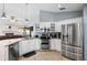 Bright kitchen featuring white cabinets, stainless steel appliances, and easy access to the living room at 6621 Appaloosa Dr, Tampa, FL 33625