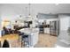 Open-concept kitchen with granite countertops, white cabinets, stainless appliances and great flow to living room at 6621 Appaloosa Dr, Tampa, FL 33625