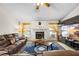 Cozy living room with fireplace, ceiling fan, and large TV, perfect for relaxing and entertaining at 6621 Appaloosa Dr, Tampa, FL 33625