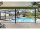 This screened lanai features a pool, spa, and beautiful lake view at 6621 Appaloosa Dr, Tampa, FL 33625
