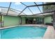 Screened in pool area with lounge chairs, ceiling fans, and view of lush landscaping at 6621 Appaloosa Dr, Tampa, FL 33625