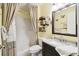 Bathroom with shower/tub combo, vanity, and decorative shelving at 6630 Spring Flower Dr # 14, New Port Richey, FL 34653
