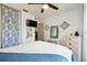 Comfortable bedroom offers a ceiling fan, closet, vanity, and tv at 6630 Spring Flower Dr # 14, New Port Richey, FL 34653