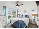 Bright bedroom with a ceiling fan, large window, and coastal decor at 6630 Spring Flower Dr # 14, New Port Richey, FL 34653