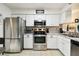 Modern kitchen featuring stainless steel appliances and sleek white cabinets at 6630 Spring Flower Dr # 14, New Port Richey, FL 34653